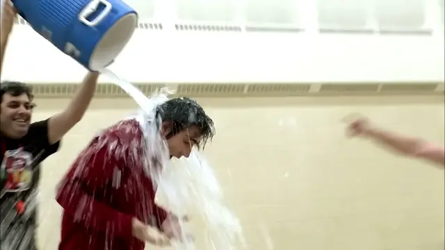 Spenny gets the cooler of liquid poured over him after Kenny wins