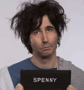 Spencer Rice holding up a Spenny sign as if he were being photo for an arrest